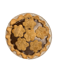 a chocolate pie with chocolate flowers on top