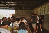a group of people standing around a table