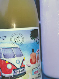 a bottle of wine next to a bottle of milk