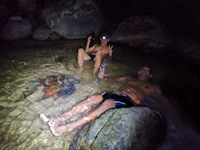 a man and woman relaxing in the water at night