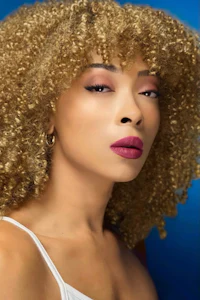 a woman with a curly afro wig
