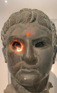a statue of a man with a red eye