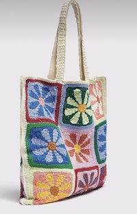 a colorful crocheted tote bag with flowers on it