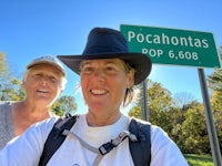 two women standing in front of a sign that says pocahontas