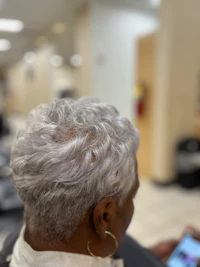 a woman in a hair salon looking at her phone