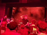 a group of people standing in front of a stage