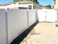 a white vinyl fence in a backyard