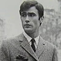 a black and white photo of a man in a suit