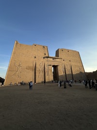 a group of people standing in front of a large building