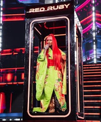 a woman in a kimono on stage with red hair