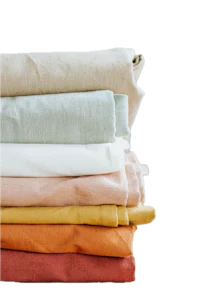 a stack of colored linens on a black background