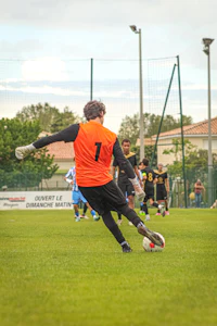 a soccer player kicking a soccer ball