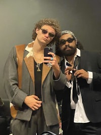 two men in suits standing next to each other