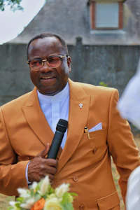 a man in an orange suit holding a microphone