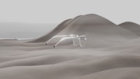 a pair of glasses in the sand with mountains in the background