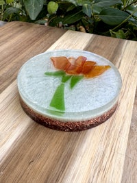 a glass plate with a flower on it