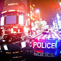 a police car on a busy street at night