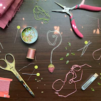 a table with scissors, thread, and other supplies on it