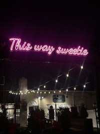 a neon sign that reads this way sweetie