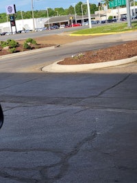 a black motorcycle parked in a parking lot
