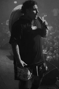 a black and white photo of a man holding a microphone