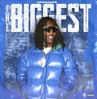 a man in a blue jacket standing in front of a blue background