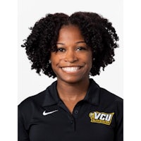 a black woman wearing a nike polo smiling