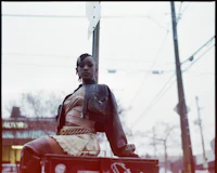 a woman is sitting on top of a box