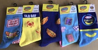 four pairs of socks with different food items on them