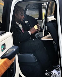 a man sitting in the back seat of a car