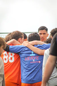 a group of soccer players huddle together