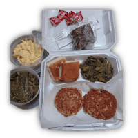 a box containing a sandwich, eggs, and greens