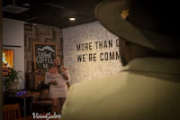 a woman in a hat is speaking to a man in a hat