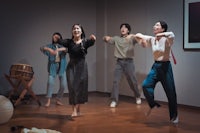 a group of people dancing in an empty room