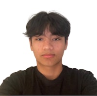 a young man in a black shirt is posing for a photo