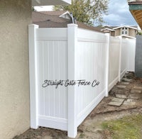 a white fence in a backyard
