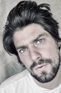 a close up of a man with a beard