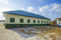 a building with green shutters and a blue roof