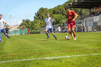 a group of men playing soccer on a grassy field
