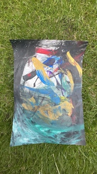 an abstract painting on a piece of grass