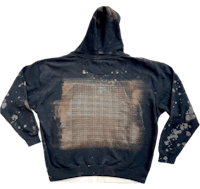 the back of a black hoodie with stains on it