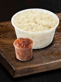 a bowl of rice next to a bowl of sauce