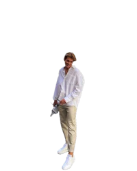a man in a white shirt standing on a black background