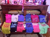 t - shirts for sale on a piano