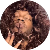 a woman wearing a wig with curly hair