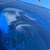 a mural of a man with a beard on the side of a building