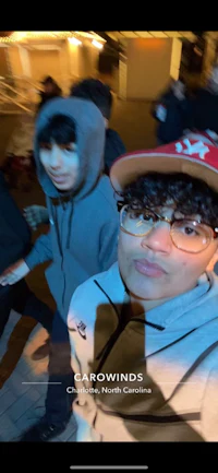 a group of people taking a selfie in front of a building
