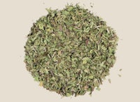 a pile of dried herbs on a white background