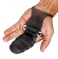 a man's hand holding a black rubber dildo