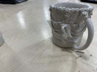 a ceramic mug is sitting on top of a table